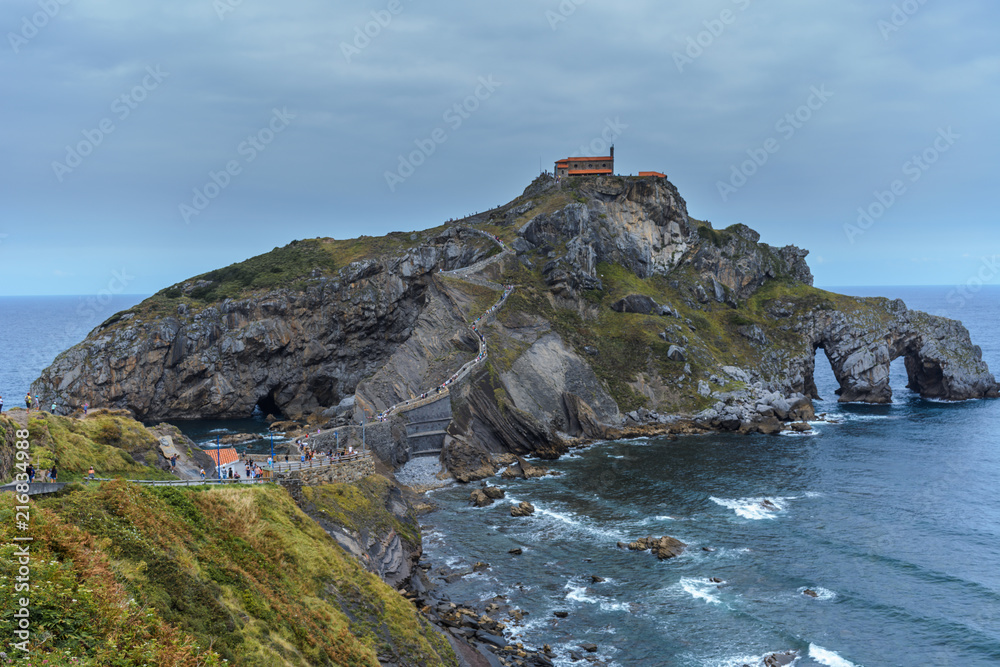 A right side view of the path & stairway to the gaztelugatxe island, low tide moment. Close up to the island at the Basque Country, Spain