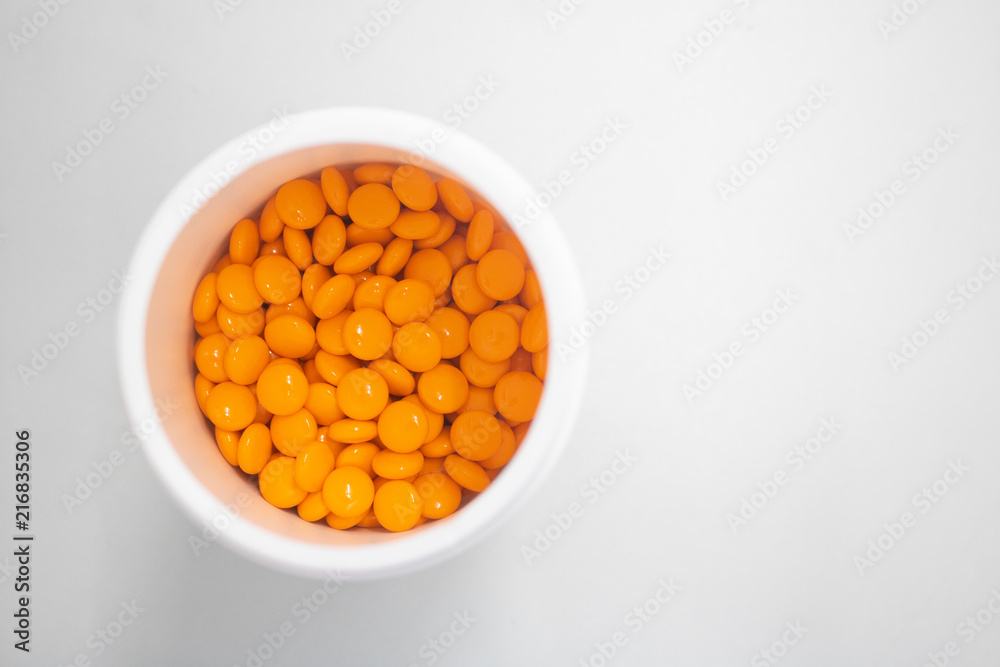 orange medicine pills in can top view orange medicine pills in can top view