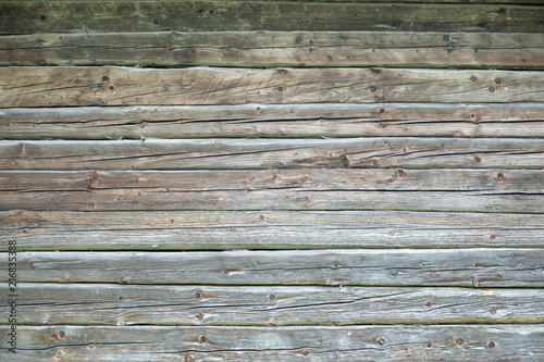 Foto Grunge background of natural old hewn logs.