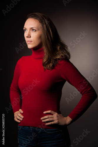 creaqtive portrait of a beautiful young caucasian happy woman in red wool kneeted sweater © Samo Trebizan