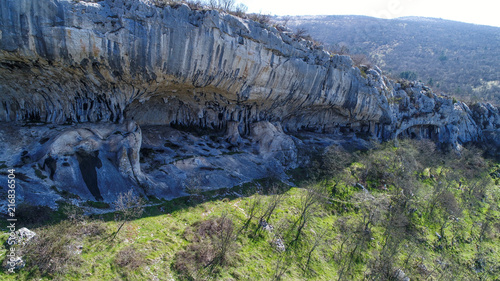 Rock shelter (abri) of Veli Badin is a shallow cave-like opening at the base of a bluff at Sočerga, Istria, Slovenia. Local people have named this rock shelters with 'Ears of Istria'. photo