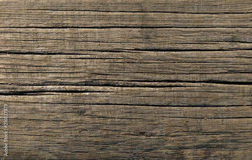 Old brown wood board surface texture. Close-up of damaged wooden floor background.