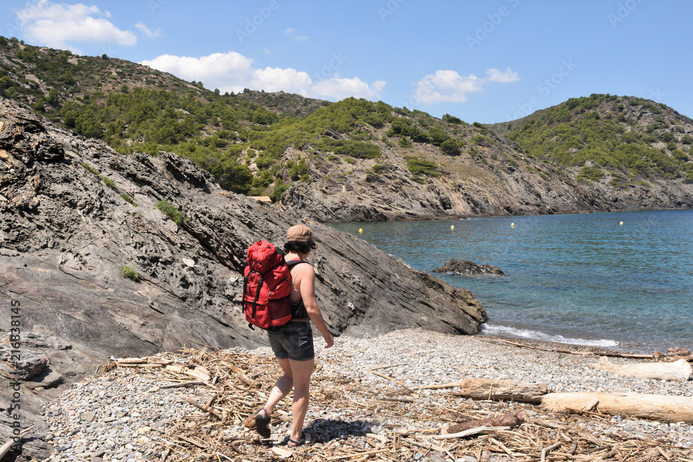 hiker woman in the Cap de Creus on the La Taballera beach, Costa Brava, Girona province, Catalonia,  Spain