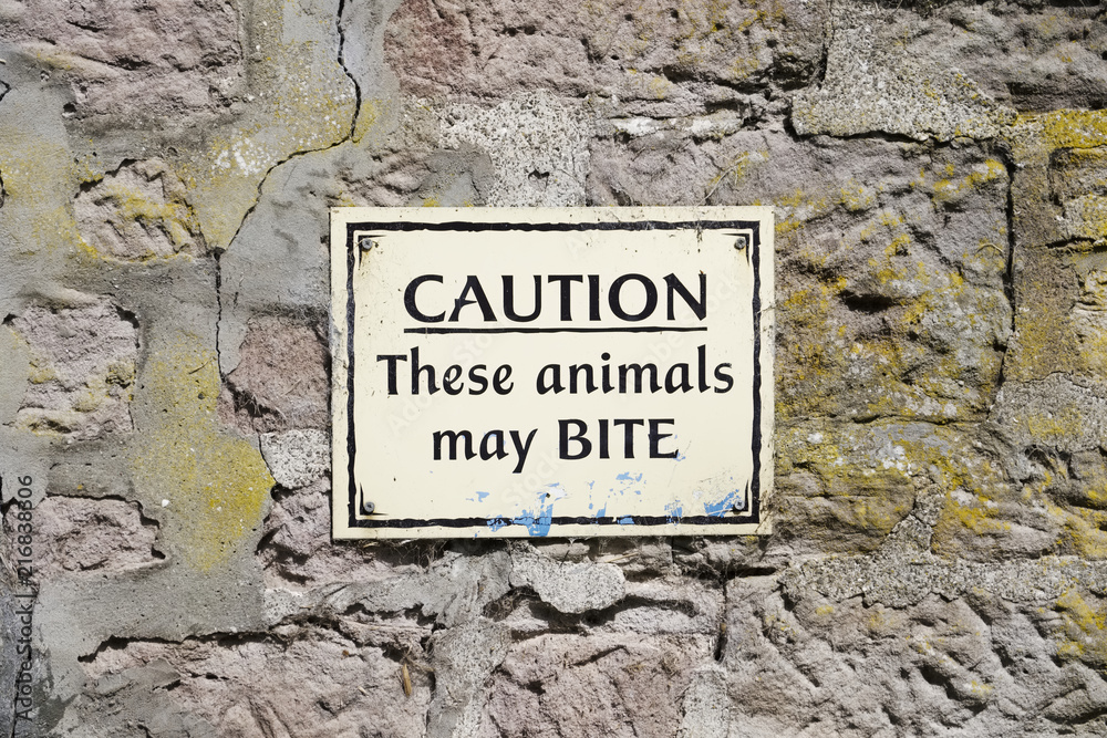 Animals may bite warning sign at zoo safari park Animals may bite warning sign at zoo safari park