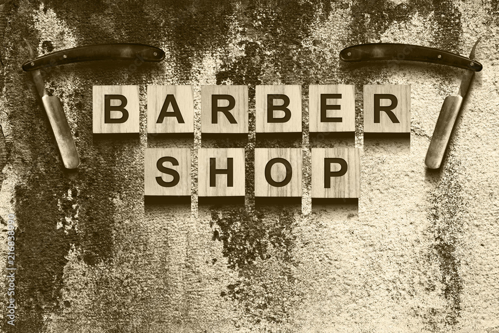 Concept Barber Shop. An inscription on wooden cubes against the background of an old vintage wall. Toned. Sepia. Concept Barber Shop. An inscription on wooden cubes against the background of an old vintage wall. Toned. Sepia.