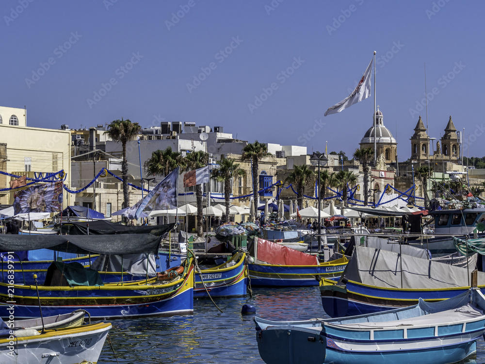Skyline of Marsaxlokk with fishermen boats in the foreground
