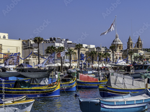 Obraz na płótnie Skyline of Marsaxlokk with fishermen boats in the foreground w salonie
