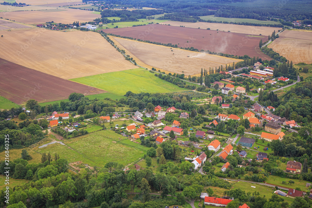 View of the Czech village from a bird's eye view. Farmers cultivate agricultural fields.