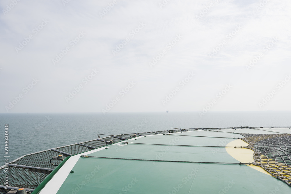 Offshore helicopter platform. Empty oil rig helipad. Sea and sky