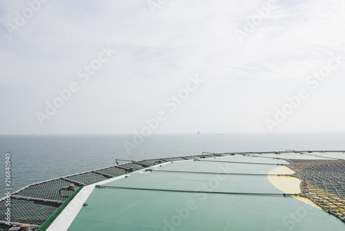 Offshore helicopter platform. Empty oil rig helipad. Sea and sky © ddukang