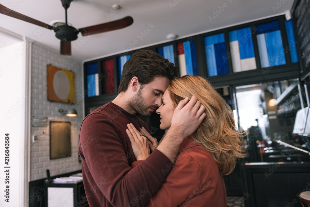 Passionate love. Pleased sincere couple looking at each other and hugging