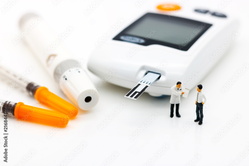 Miniature people: Doctors standing with glucose meter of diabetes  and injection needle , business and health care concept.