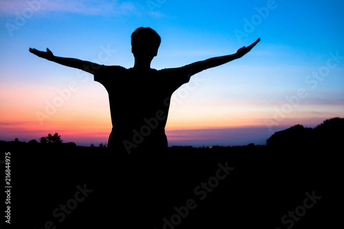 Blurr. Silhouette,Asian young man in hat hiking standing open arm happy at mountain peak above sunset ligth, Hiker outdoor.