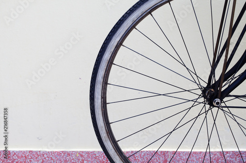 bicycle wheel with wall space background.