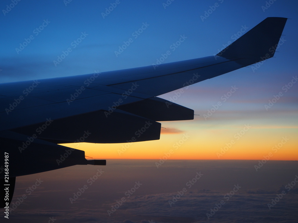 View from an airplane window to see the sky in the evening time at sunset in beautiful colors. View from an airplane window to see the sky in the evening time at sunset in beautiful colors.