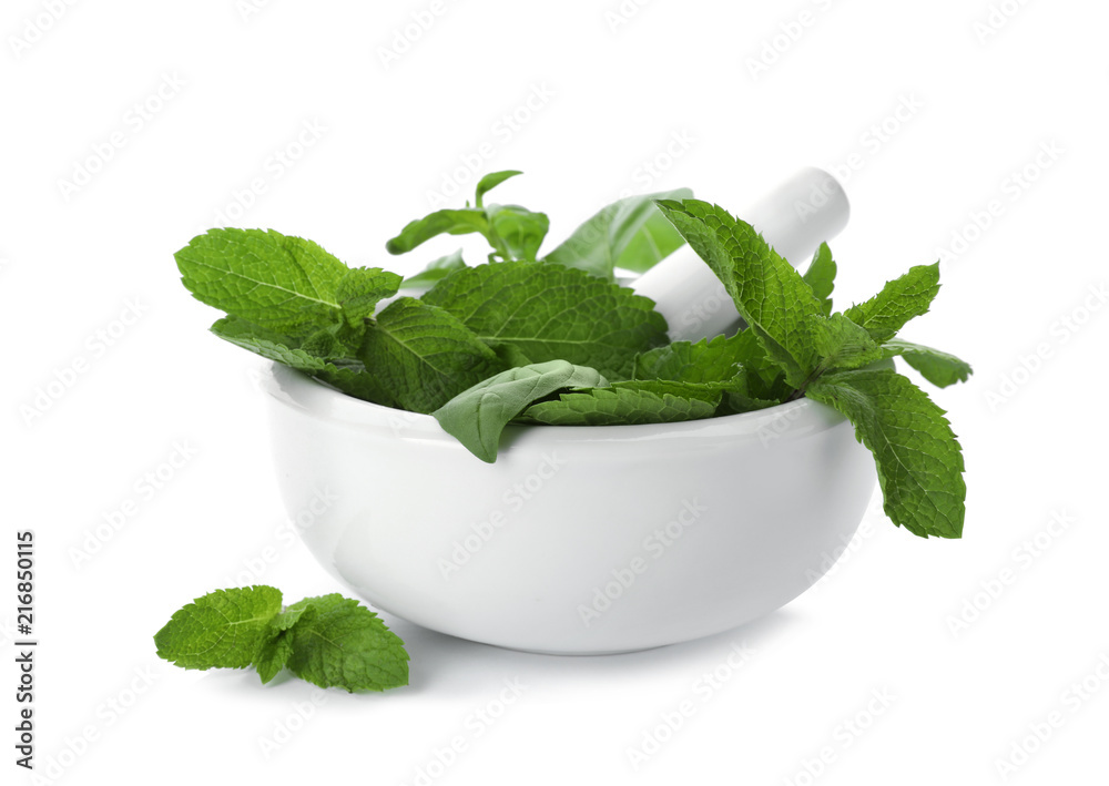 Mortar with fresh green herbs on white background Mortar with fresh green herbs on white background