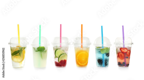 Plastic cups with lemonades on white background