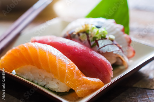 Sushi salmon & tuna sushi shrimp and wasabi on the white plate.selective focus