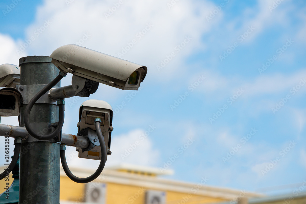 Security CCTV camera with blue sky in background Security CCTV camera with blue sky in background