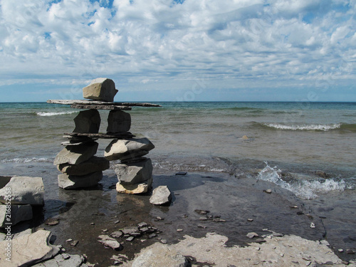 Inukshuk native rock symbol in Canada Nova Scotia at peggy's cove on the sea shore