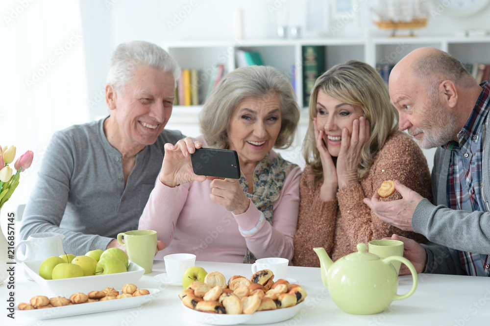 Senior couples taking selfie with smartphone at home Senior couples taking selfie with smartphone at home