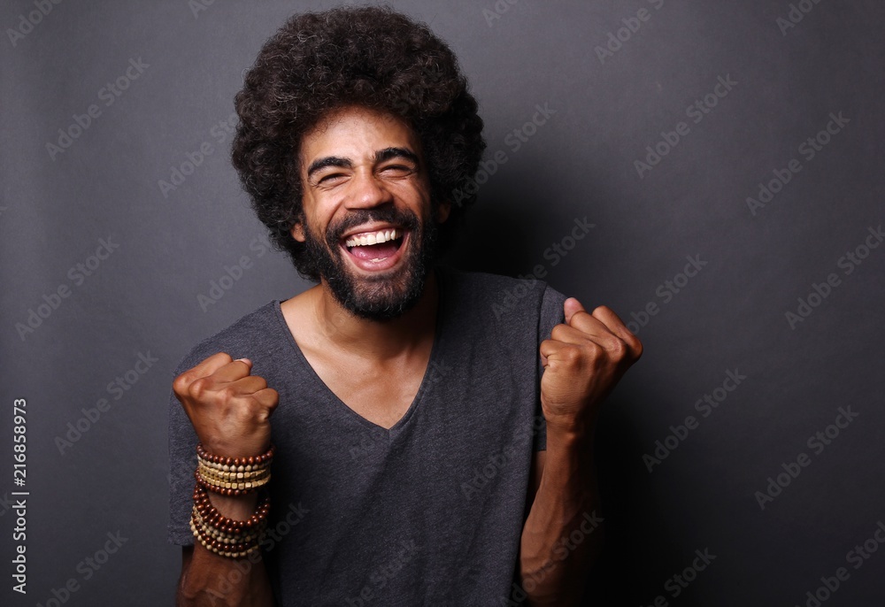 Afro man in front of a grey background Afro man in front of a grey background