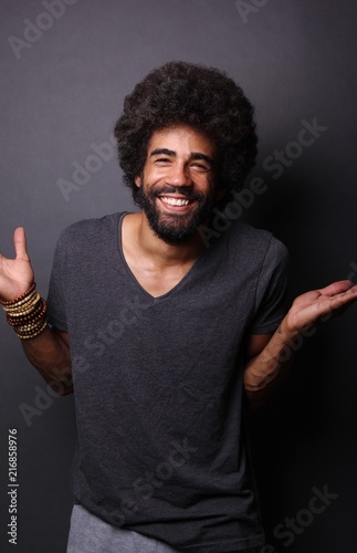 Afro man in front of a grey background