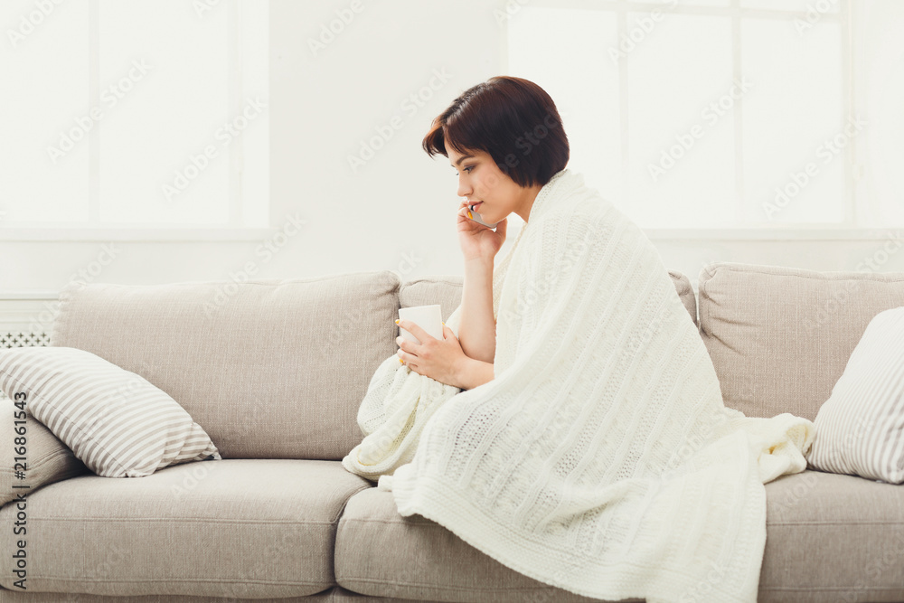 Girl in a blanket with mobile and drinking coffee Girl in a blanket with mobile and drinking coffee