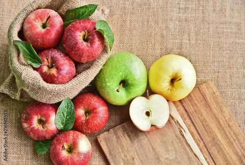 colorful of 3 Type of apple,Gala,Granny Smith,Golden Delicious with leaf in sack back and sack background.