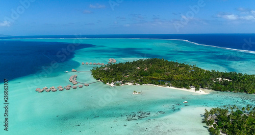 Fototapeta Naklejka Na Ścianę i Meble -  Water bungalows resort at islands, french polynesia in aerial view