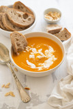 pumpkin soup with bread on white background