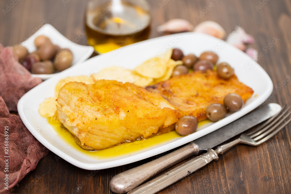 fried cod fish with olive oil on dish