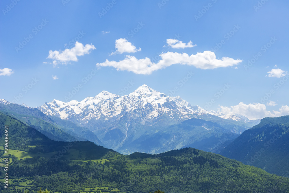 Beautiful mountains landscape on sunny clear summer day. Georgian nature. Hills and mountain snowy peak. Caucasus Svaneti rocky mounts.