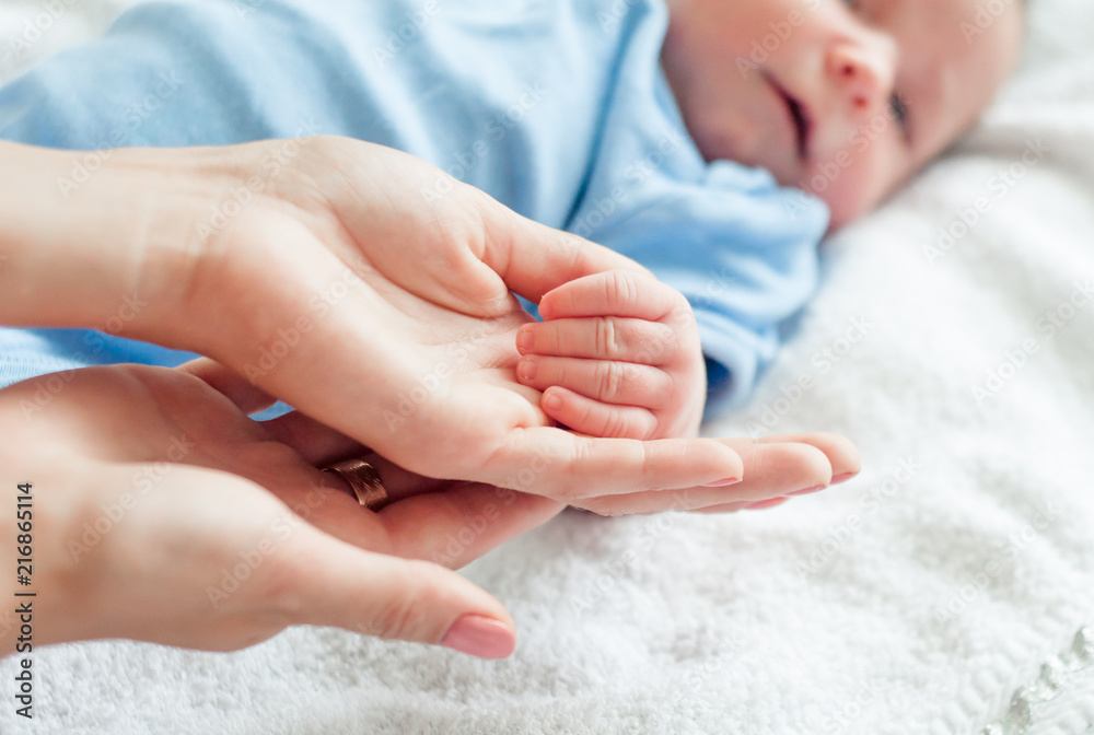 Cute newborn baby holding mother's hand Cute newborn baby holding mother's hand