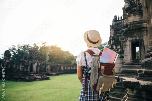 Young women are traveller enjoying a looking at sunset ,phimai castle thailand,Traveling along Asia.