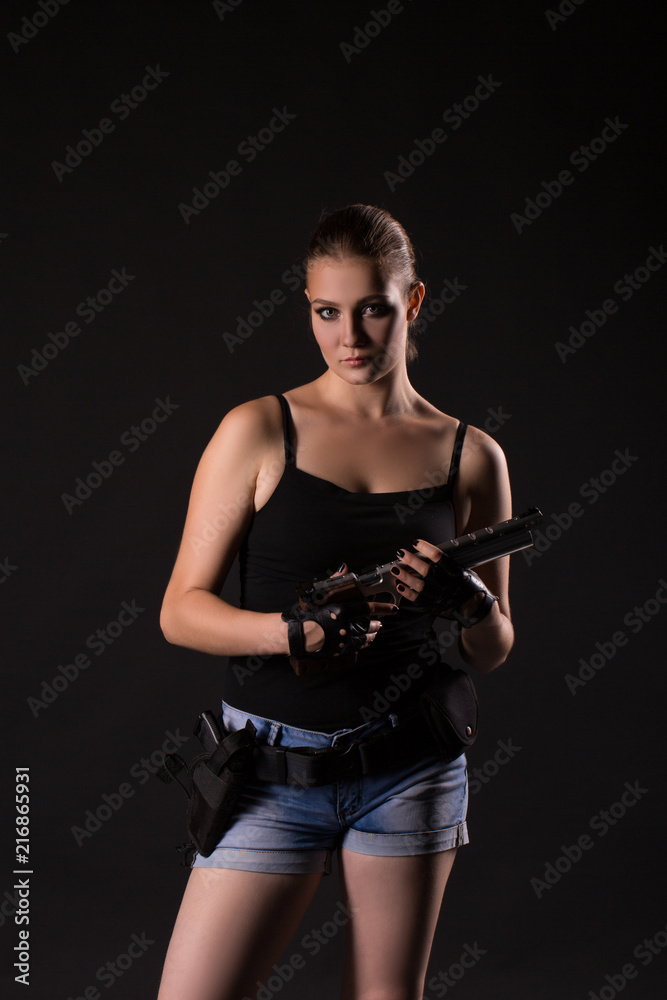 Military woman with a sport gun over black background Military woman with a sport gun over black background