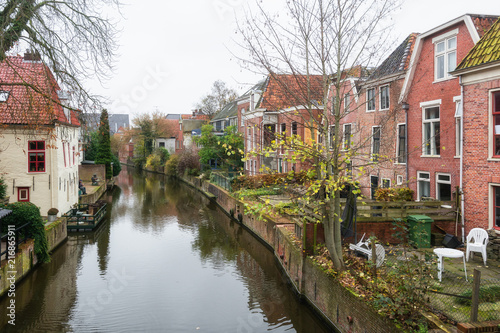 Houses along the canal Damsterdiep in the Dutch village Appingedam © julia700702