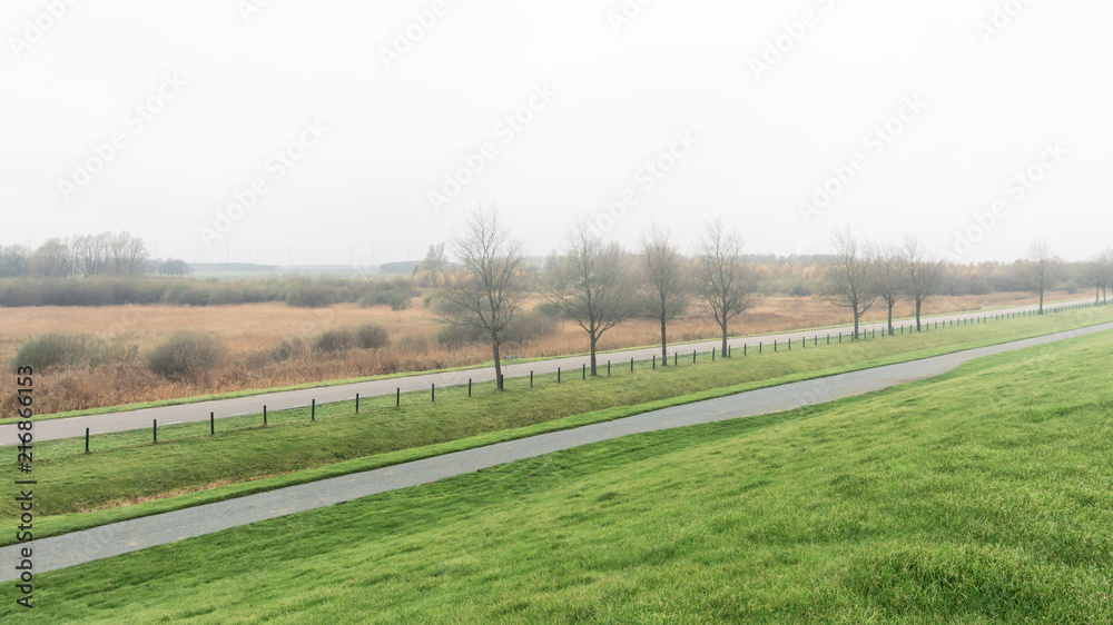 Windmill park in the mist in the Dutch province of Groningen