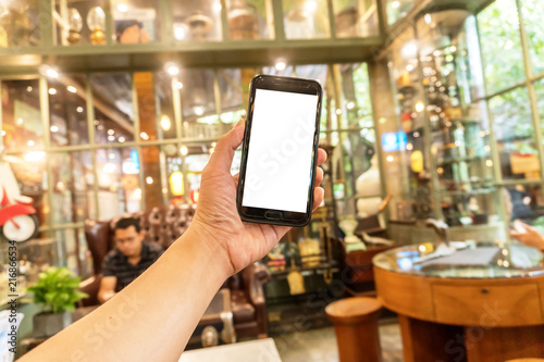 close up smartphone in coffee shop with on white on screen background.