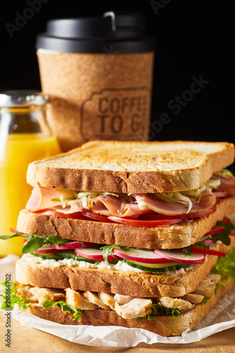 Thick fresh sandwich with ham and vegetables