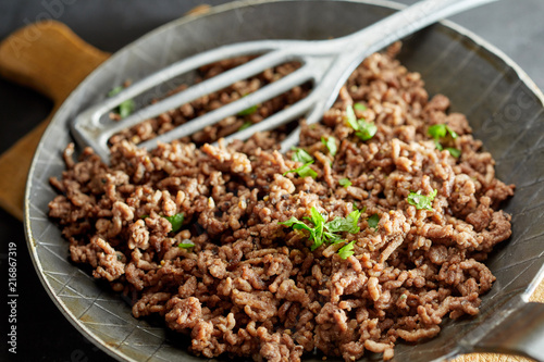 Fried minced meat on pan with green chives
