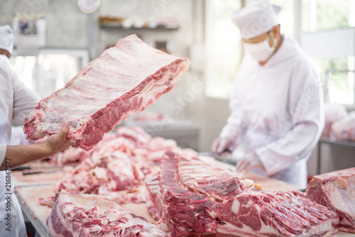 Butcher cutting pork meat food industry concept