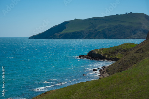 Beautiful green slopes of the mountains by the sea.