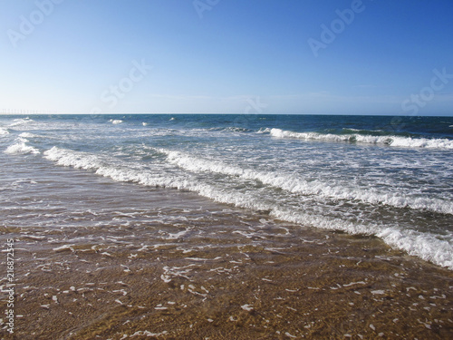 Water surface of sea or ocean with horizon and blue sky or sea with low waves - Aracati, Fortaleza, Ceara, Brazil photo