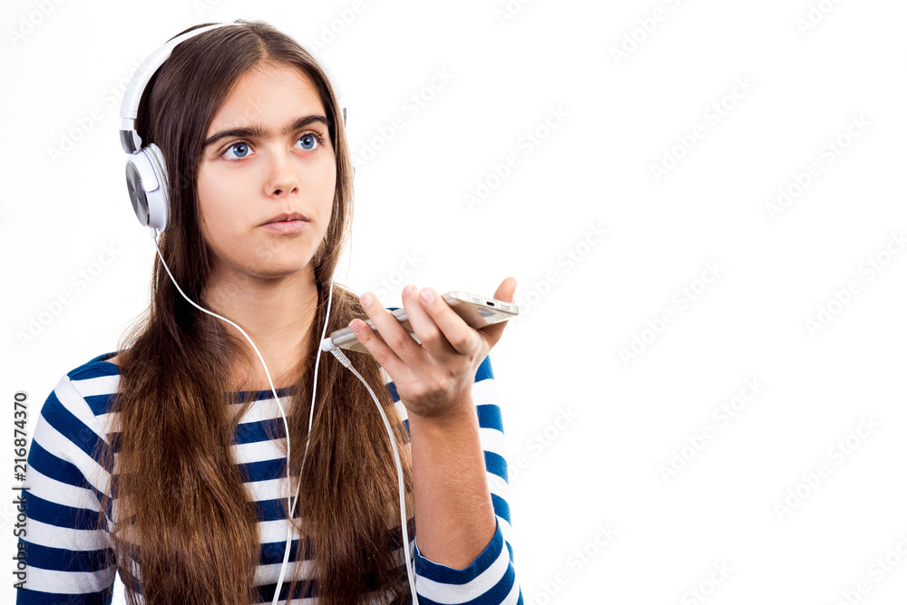 young beautiful girl speaks by mobile phone. Girl with headphones and mobile phone. student talks to her friend. modern Teenager on a white background
young beautiful girl speaks by mobile phone. Girl with headphones and mobile phone. student talks to her friend. modern Teenager on a white background