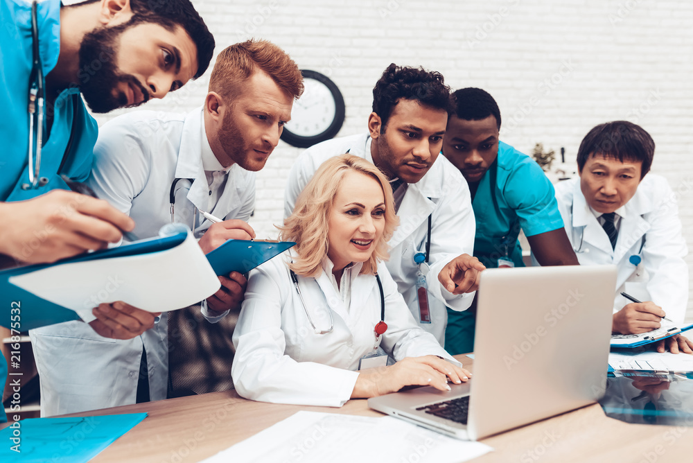 Hospital Multinational Doctors Looking On Laptop. Hospital Multinational Doctors Looking On Laptop.