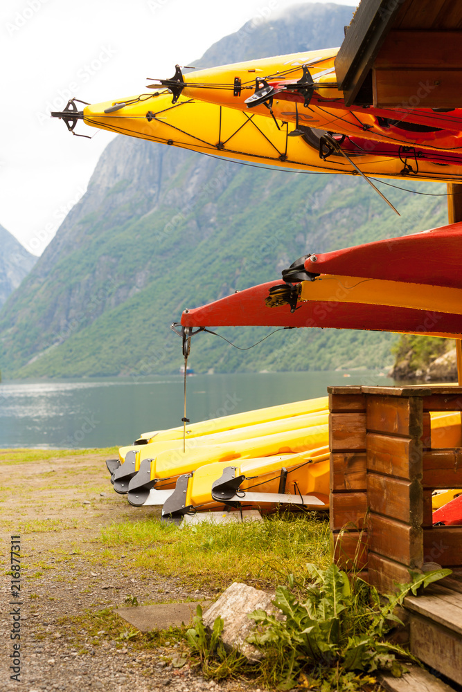 Many canoes on norwegian fjord shore