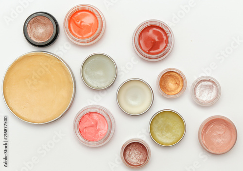 Creamy make up products - top view of decorative cosmetic containers isolated on white backgroiunds