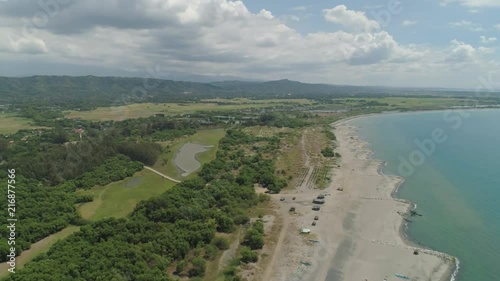 Aerial view of coastline with sandy beach, azure water on the island Luzon, Philippines. Seascape, ocean and beautiful beach. Agoo Damortis National Seashore Park. photo