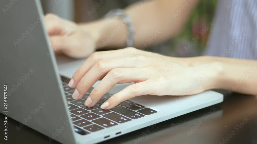 Businesswoman using laptop computer. Close up of female hand typing on laptop keyboard. Concept blogger, writing new article, photographer. Businesswoman using laptop computer. Close up of female hand typing on laptop keyboard. Concept blogger, writing new article, photographer.